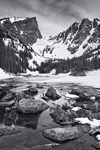 Snow and Ice still partially cover Dream Lake in Rocky Mountain National Park on a cold May morning. - Colorado Photograph