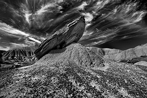 Wispy clouds float above a toadstool at Toadstool Geologic Park in Western Nebraska. - Nebraska Photograph