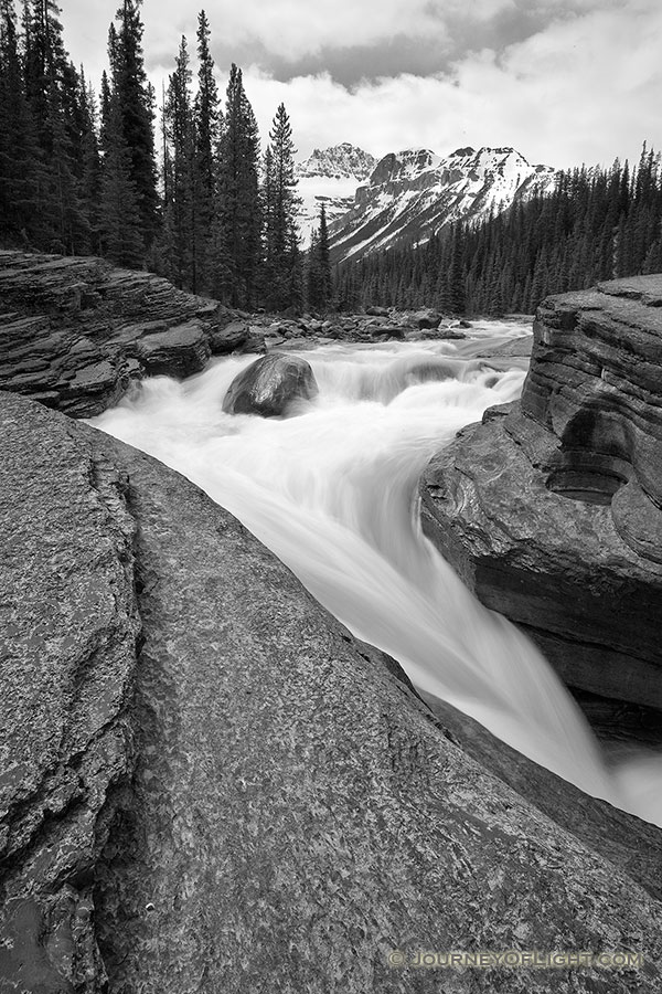 Water runs fast through Mistaya Canyon in the spring during the snow melt. - Canada Photography