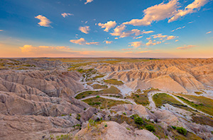 A scenic landscape photograph of sunset over the badlands Toadstool Geologic Park in western Nebraska. - Nebraska Photograph