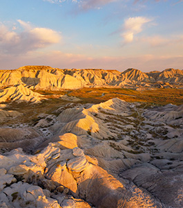 A vertical scenic photograph of the badlands Toadstool Geologic Park in western Nebraska. - Nebraska Photograph