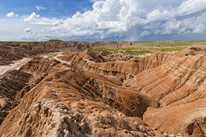 From a high point at Toadstool Geologic Park a storm can be seen in the distance moving slowly across the Oglala Grasslands. - Nebraska Photograph