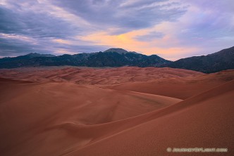 As the last of the light of the day diminishes at Great Sand Dunes National Park, a single set of clouds remain illuminated before quietly going dim.
