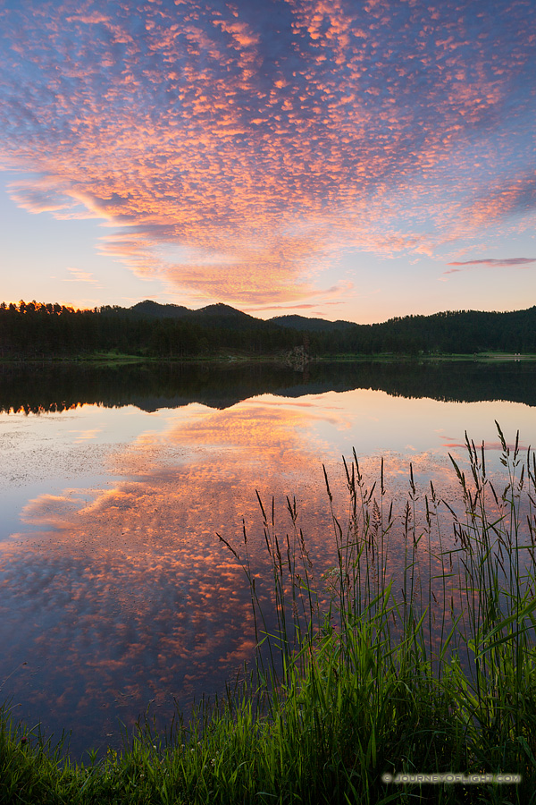 Stockade Lake in the Black Hills of South Dakota reflects the warmth of the rising sun.