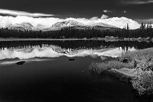 Just after a short storm rolled through, Red Rock Lake was still reflecting the mountains and clouds in the distance. - Colorado Photograph