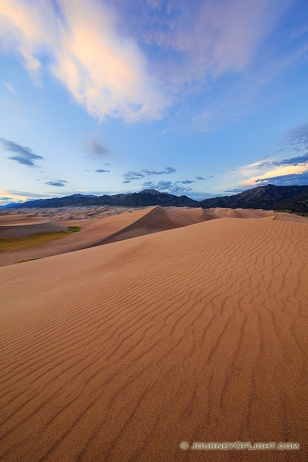 A rare combination of geologic forces combine to create these massive dunes, the largest in North America.  Rising in the distance is Mt. Herard, one of the tallest mountains of the San Juan range. - Great Sand Dunes NP Photography