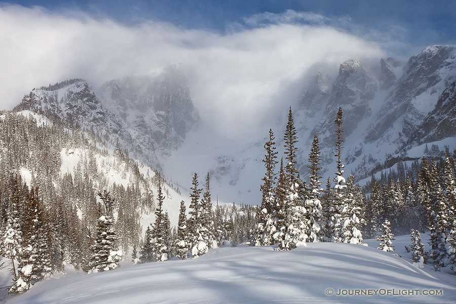 Hallet and Flattop are partially hidden by the blowing snow and clouds due to a large mid-May snowfall. - Rocky Mountain NP Photography