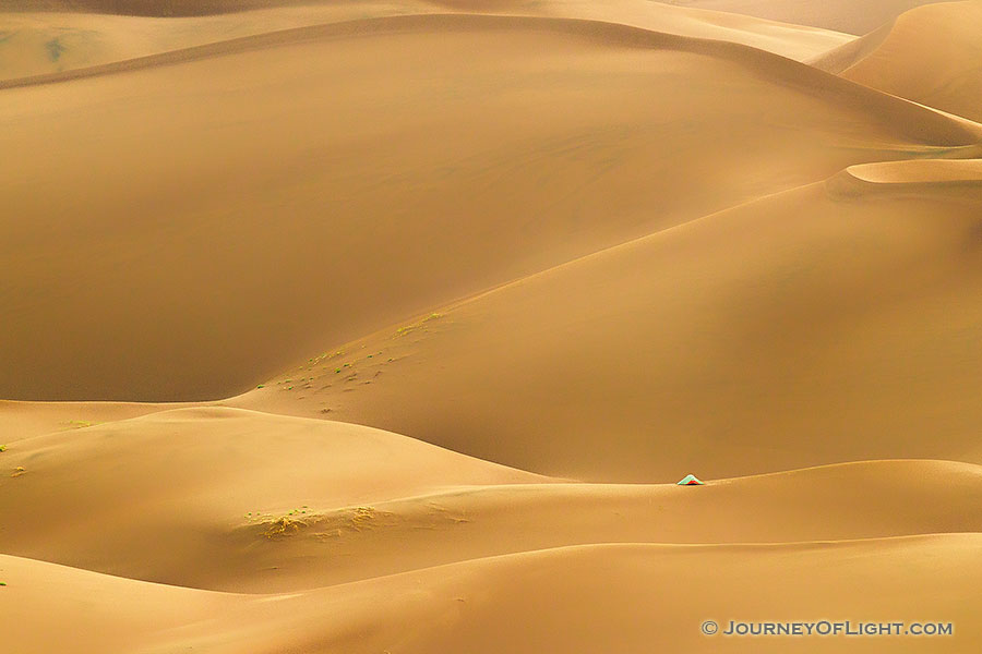 A tent stands on a distant dune in Great Sand Dunes National Park and Preserve in south central Colorado. - Colorado Photography