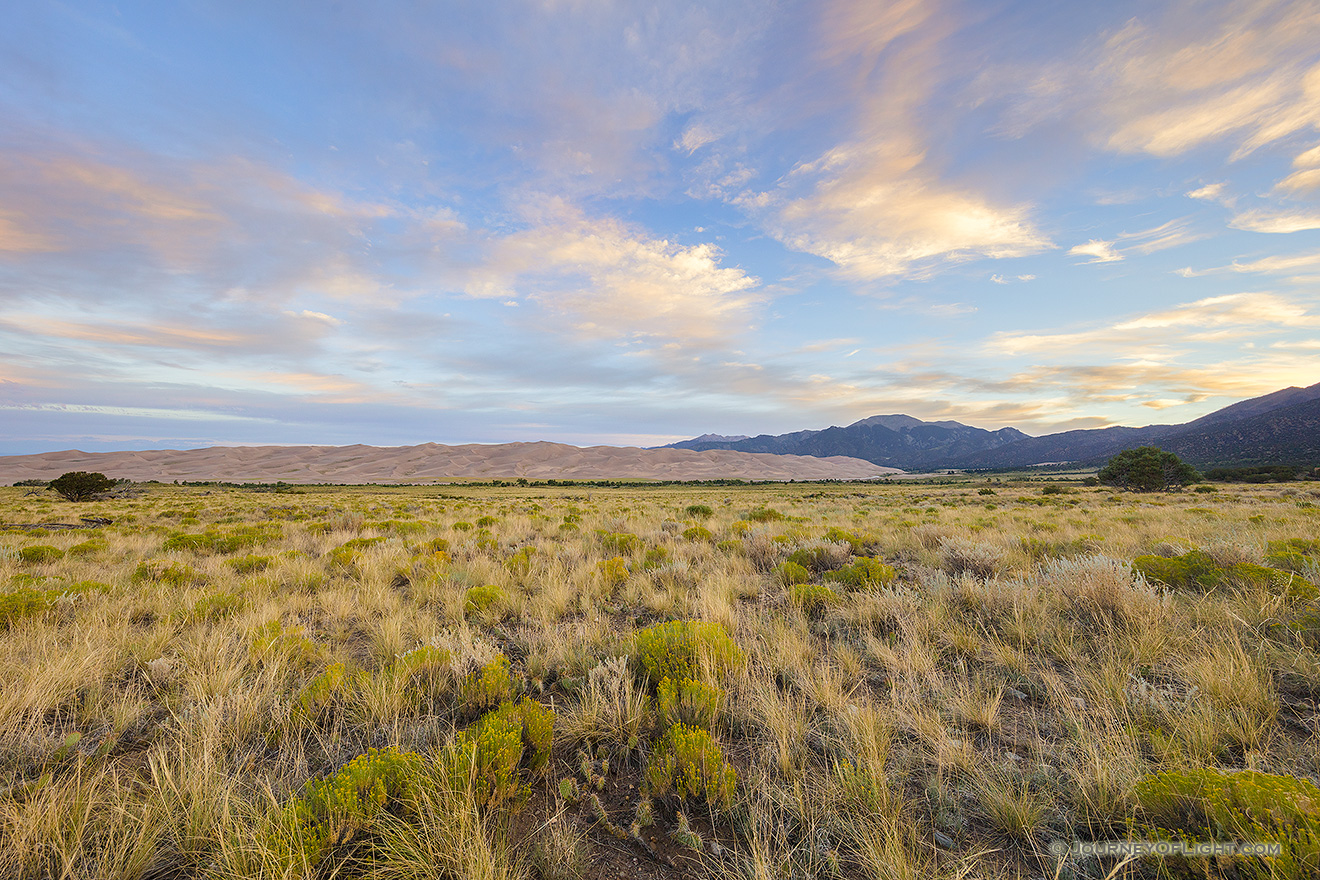 The sun rises over the Sangre De Cristo Range and the Great Sand Dunes. - Great Sand Dunes NP Picture