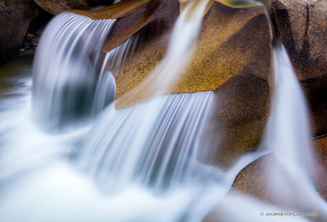 Water has smoothed the surface after thousands of years, constantly flowing across these rocks creating a unique pattern.  Grottos Waterfall in the White River National Forest in Colorado. - Colorado Picture