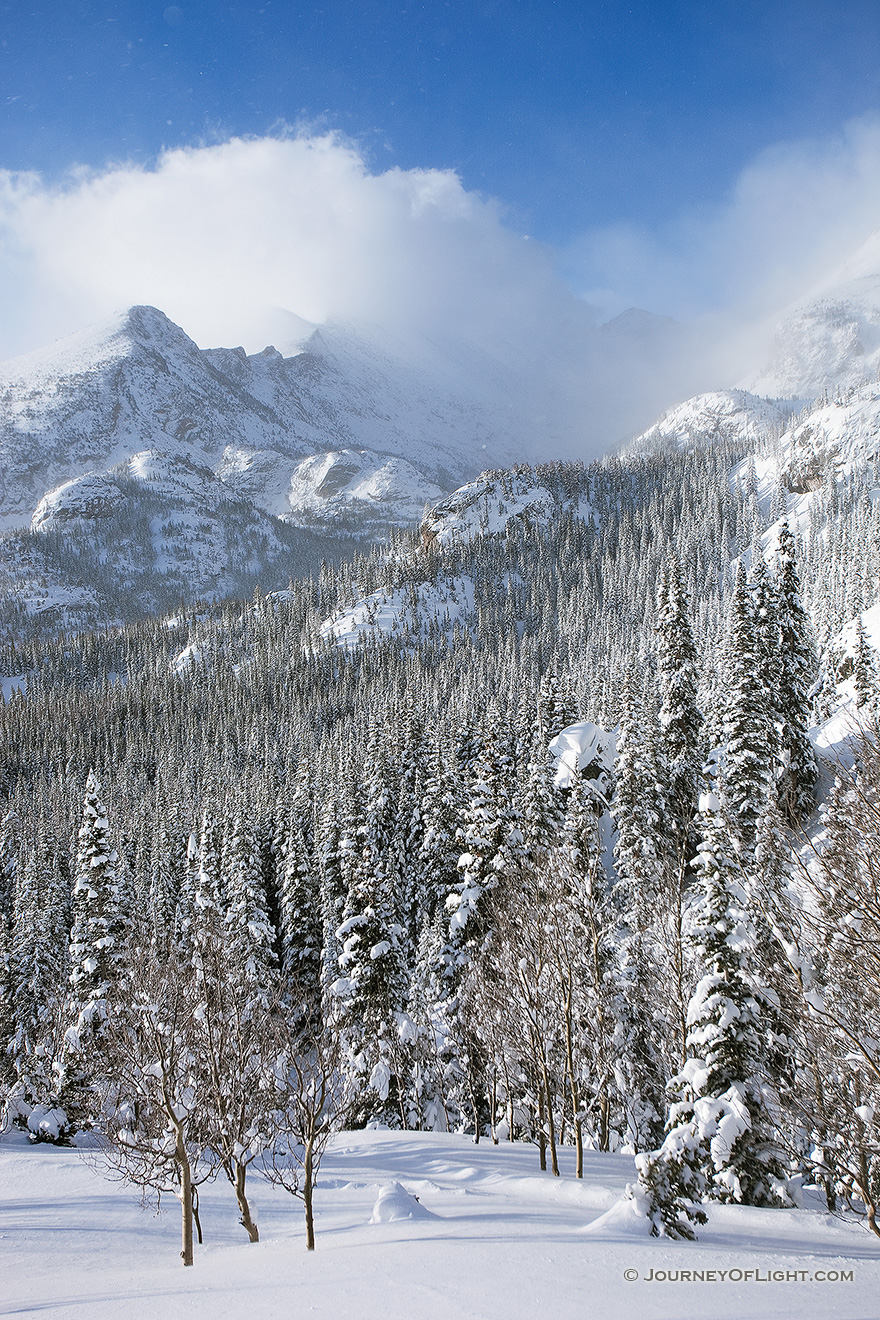 On the trail to Dream Lake, Long's Peak is obscured, encased in blowing snow and clouds in Rocky Mountain National Park, Colorado. - Rocky Mountain NP Picture