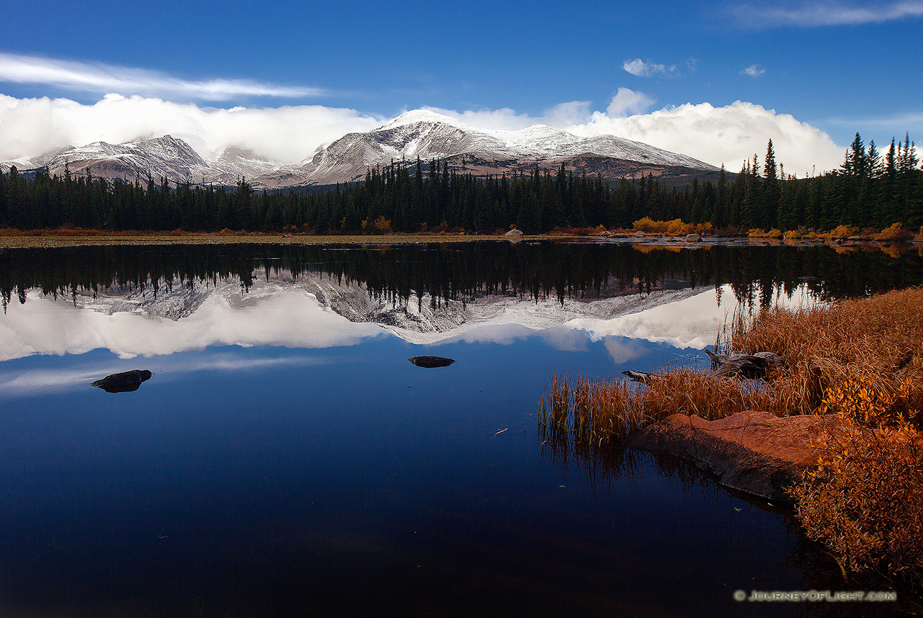 Just after a short storm rolled through, Red Rock Lake was still reflecting the mountains and clouds in the distance. - Colorado Picture