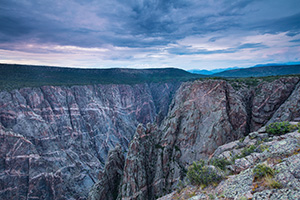 Dusk descends on the Black Canyon of the Gunnison.  The cool blue hues began to prevail throughout the sky and are reflected in the canyon walls. - Colorado Photograph