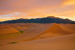 With no wind there is a complete silence on the dunes while the sunrise bathes the landscape in a warm glow a Great Sand Dunes National Park, Colorado. - Colorado Landscape Photograph