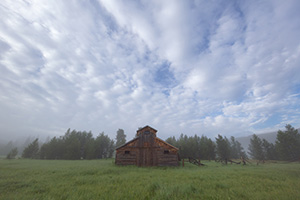 Fog engulfs the Kawuneeche Valley creating an eerie quiet near this old rustic barn in Rocky Mountain National Park. - Colorado Landscape Photograph