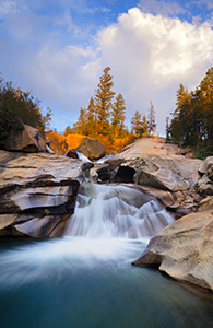The soothing swoosh of the waterfall was the other sound as the warm last light strikes trees above the Grottos Waterfall in the White River National Forest in Colorado. - Colorado Landscape Photograph