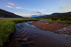 The head of the Colorado River runs through the Kawuneeche Valley in western Rocky Mountain National Park.  Here it is a quiet stream that is quite easy to across, much different than the raging river found at the bottom of the Grand Canyon. - Colorado Landscape Photograph Photograph