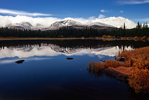 Just after a short storm rolled through, Red Rock Lake was still reflecting the mountains and clouds in the distance. - Colorado Photograph