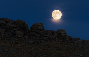 As the sun descended in the west, an eerie glow began to illuminate the east.  Within a few minutes the glowing orb of the moon rose silently above the tundra. - Colorado Photograph