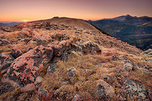 On this day, as many days through time, the exposed rocks on the tundra area of Rocky Mountain National Park bear witness to the rising sun and its illumination of Longs Peak. - Colorado Photograph