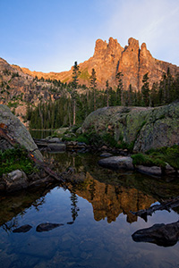 The summer sun shines a warm glow on Ptarmigan Mountain it's reflection in an outlet of Lake Nanita below. - Colorado Landscape Photograph Photograph