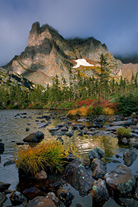 Light filters through the clouds during a short break in a rain storm that brought rain and sleet to Lake Helene. - Colorado Photograph