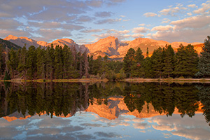 During a cool October sunrise the peaks of the continental divide, Powell Peak, Taylor Peak, Otis Peak, Hallett Peak, and Flattop Mountain are reflected in the calm waters of Sprague lake. - Colorado Photograph