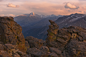 Longs peak is visible with the last light of the day through the rock cut on the alpine area of Rocky Mountain National Park. - Colorado Photograph