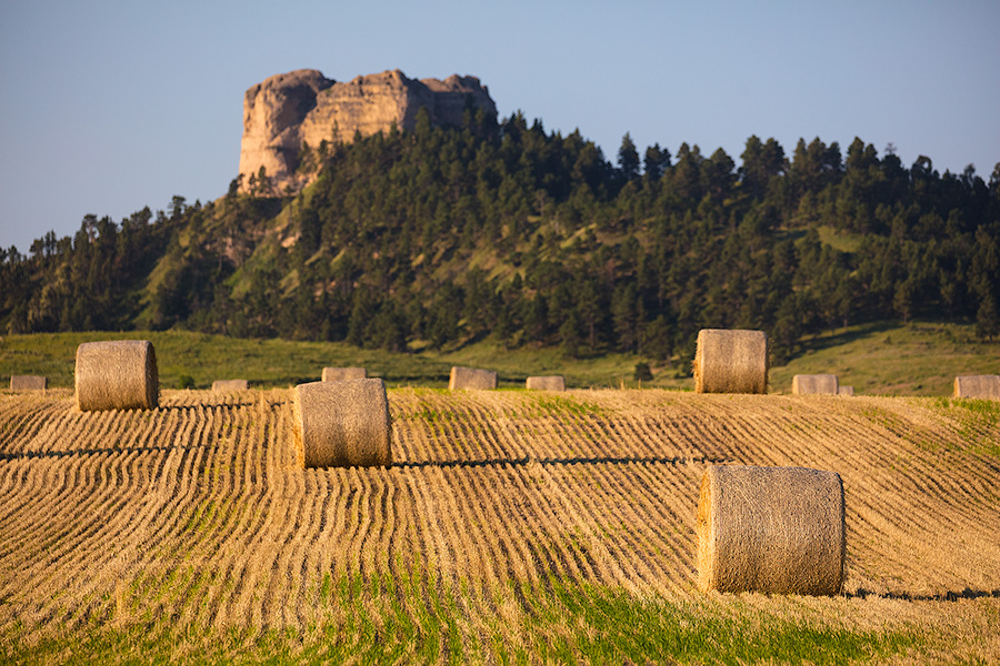 A Nebraska photograph of Hay Bales in the morning under Lovers Leap at Fort Robinson State Park. - Nebraska Photography