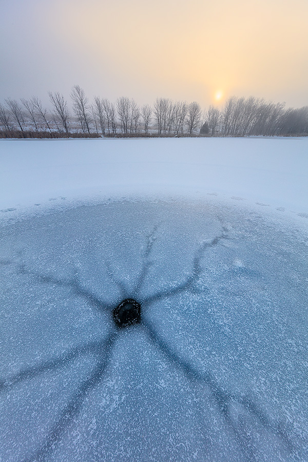 A scenic landscape photograph of fog over a frozen lake with the sunrise at Walnut Creek, Nebraska. - Nebraska Photography