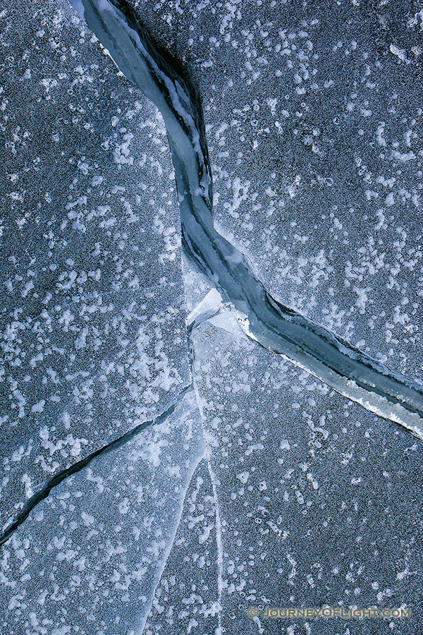 Deep cracks form in the ice from frigid cold weather on Lake Wehrspann at Chalco Hills, Nebraska. - Nebraska Photography