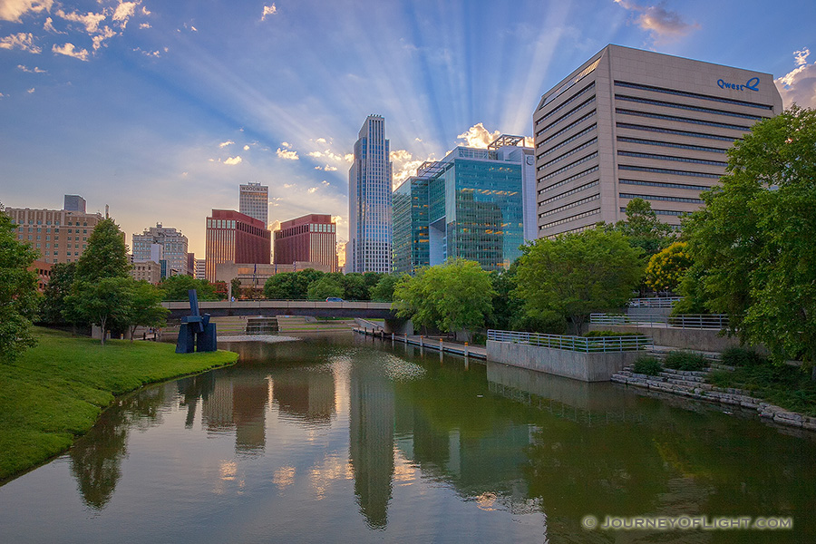 During a spring evening in Omaha, Nebraska I witnessed some spectacular godbeams.  This is the Gene Leahy Mall which runs down the center of downtown. - Omaha Photography