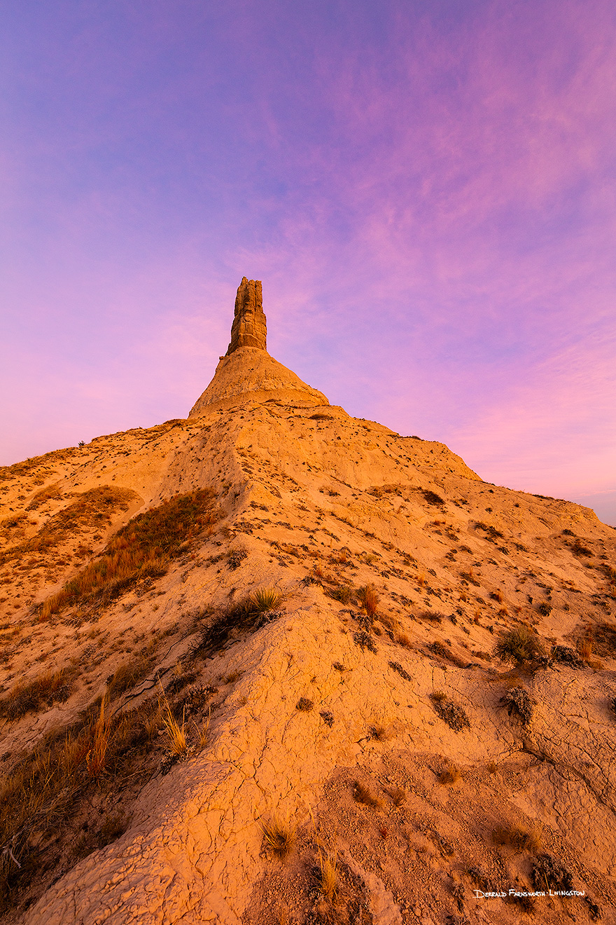 A scenic vertical landscape Nebraska photograph of a sunset and Chimney Rock in western Nebraska. - Nebraska Picture