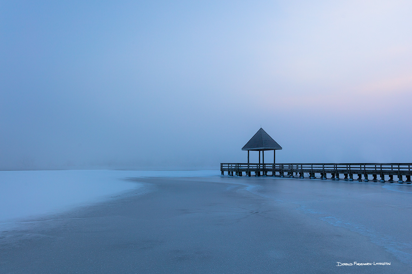 A scenic landscape photograph of fog over a frozen lake and a dock at Walnut Creek, Nebraska. - Nebraska Picture