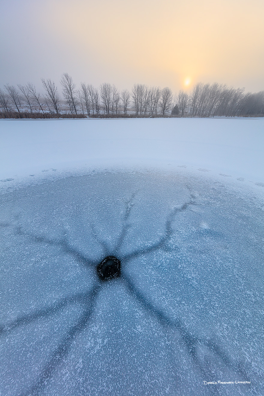 A scenic landscape photograph of fog over a frozen lake with the sunrise at Walnut Creek, Nebraska. - Nebraska Picture