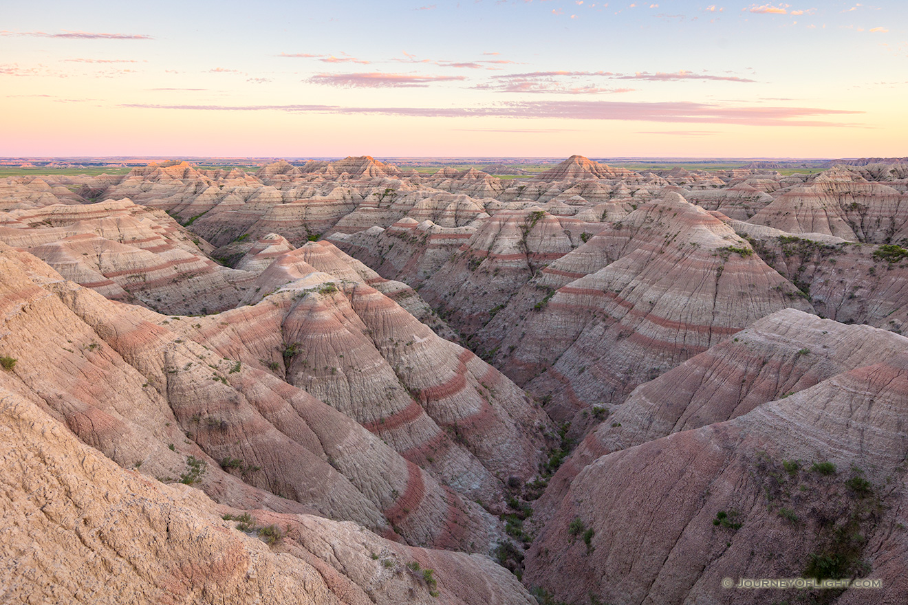 Dusk comes to Badlands National Park and the landscape is bathed in pastel hues. - South Dakota Picture
