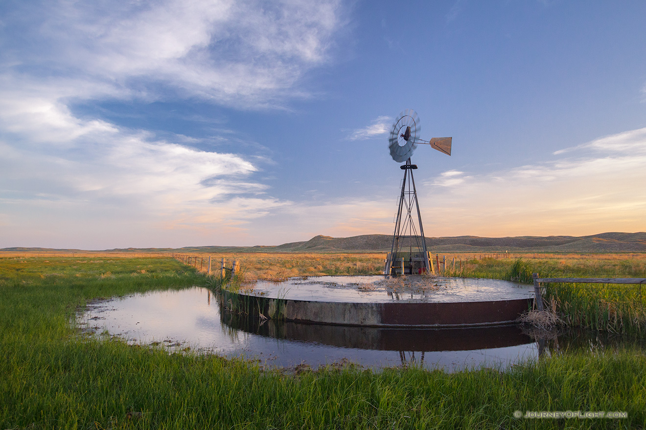 On a breezy evening in Crescent Lake National Wildlife Refuge a windmill stands like a sentinel among the sandhills. - Nebraska Picture