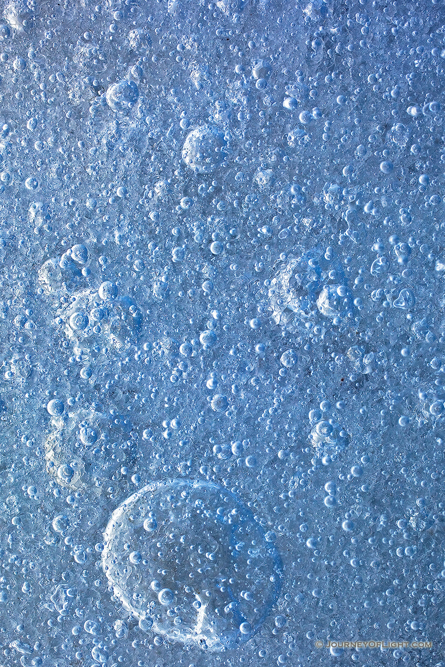 An abstract of bubbles formed in the frozen lake. - Nebraska Picture