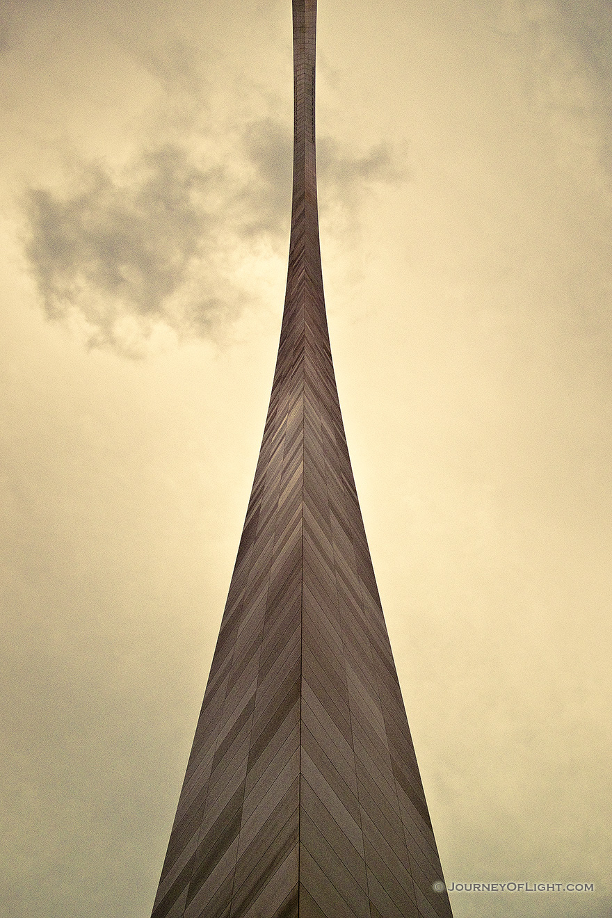 Built between February 12, 1963, and October 28, 1965 the Gateway Arch in St. Louis was designed to honor the westward expansion of the United States.  Designed by architect Eero Saarinen and engineer Hannskarl Bandel, it is 630 feet wide at its base and 630 feet tall and is currently the tallest monument in the United States.  From the base of the north leg looking in a south easterly directly, the structure curves through the sky almost touching the low clouds.  - Jefferson National Expansion Memorial Picture