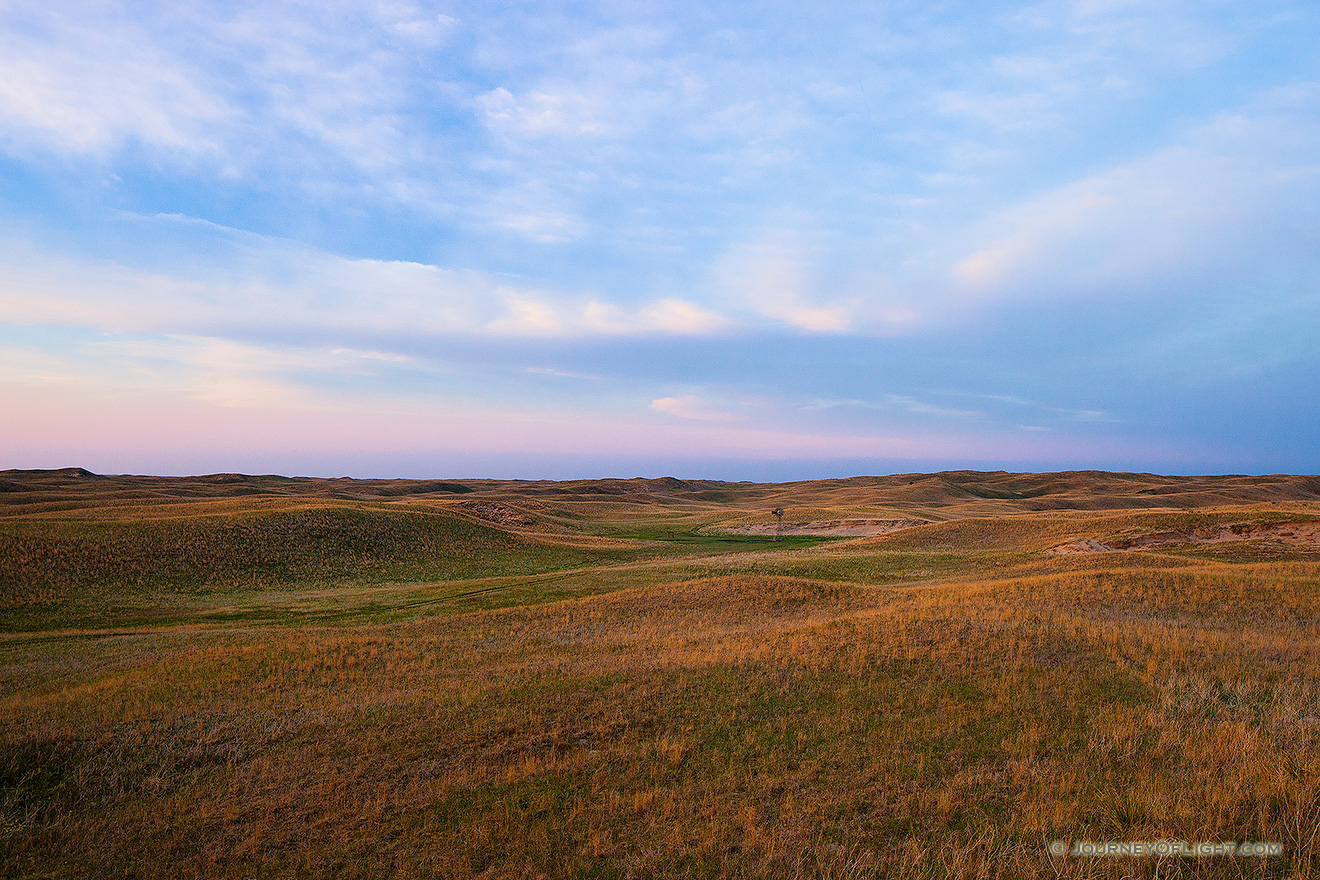 The last light of Day illuminates a windmill nestled in the sandhills on the western edge of Halsey National Forest. - Sandhills Picture