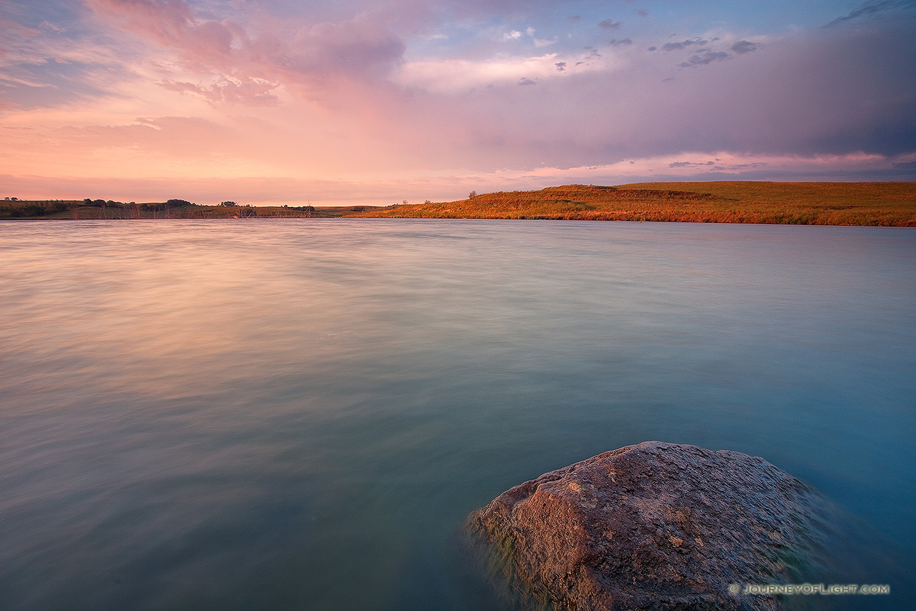 Just after sunrise on a summer's morning, warm light illuminates Powder Creek Wildlife Management Area in northwestern Nebraska. - Nebraska Picture