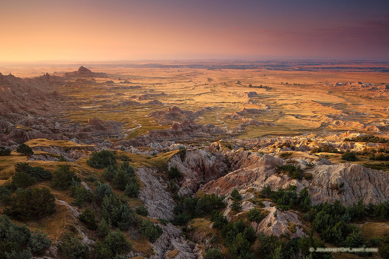 One of my favorite hikes in the Badlands is the Notch trail.  Not for those who fear heights, to take this trail you must ascend a ladder and then climb above a canyon.  From the notch, the first light of day illuminates the unique landscape of the Badlands National Park in South Dakota. - South Dakota Picture