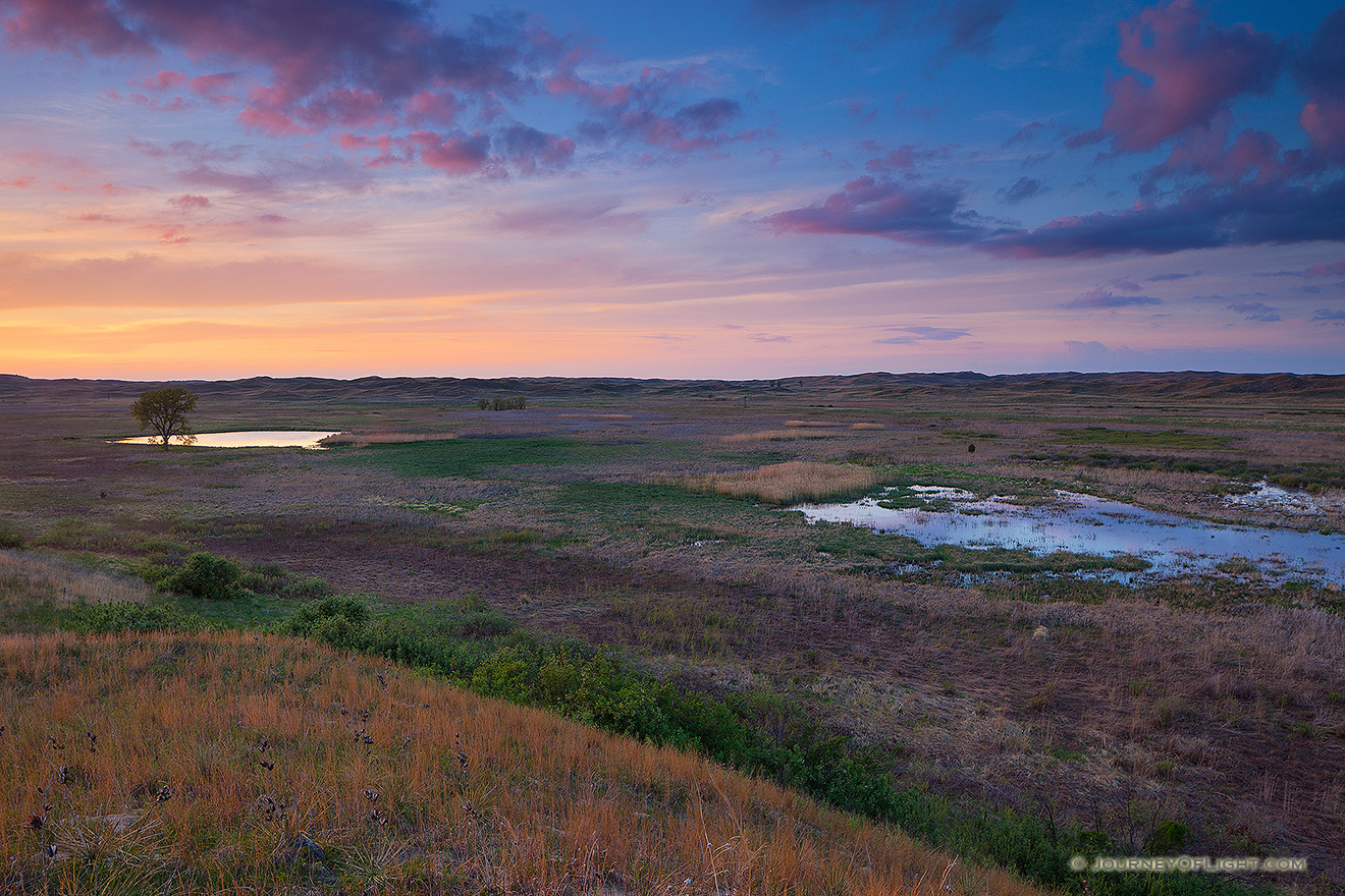 As twilight approaches, clouds float lazily above Valentine National Wildlife Refuge and reflect the pinks and purples of sunset. - Valentine Picture