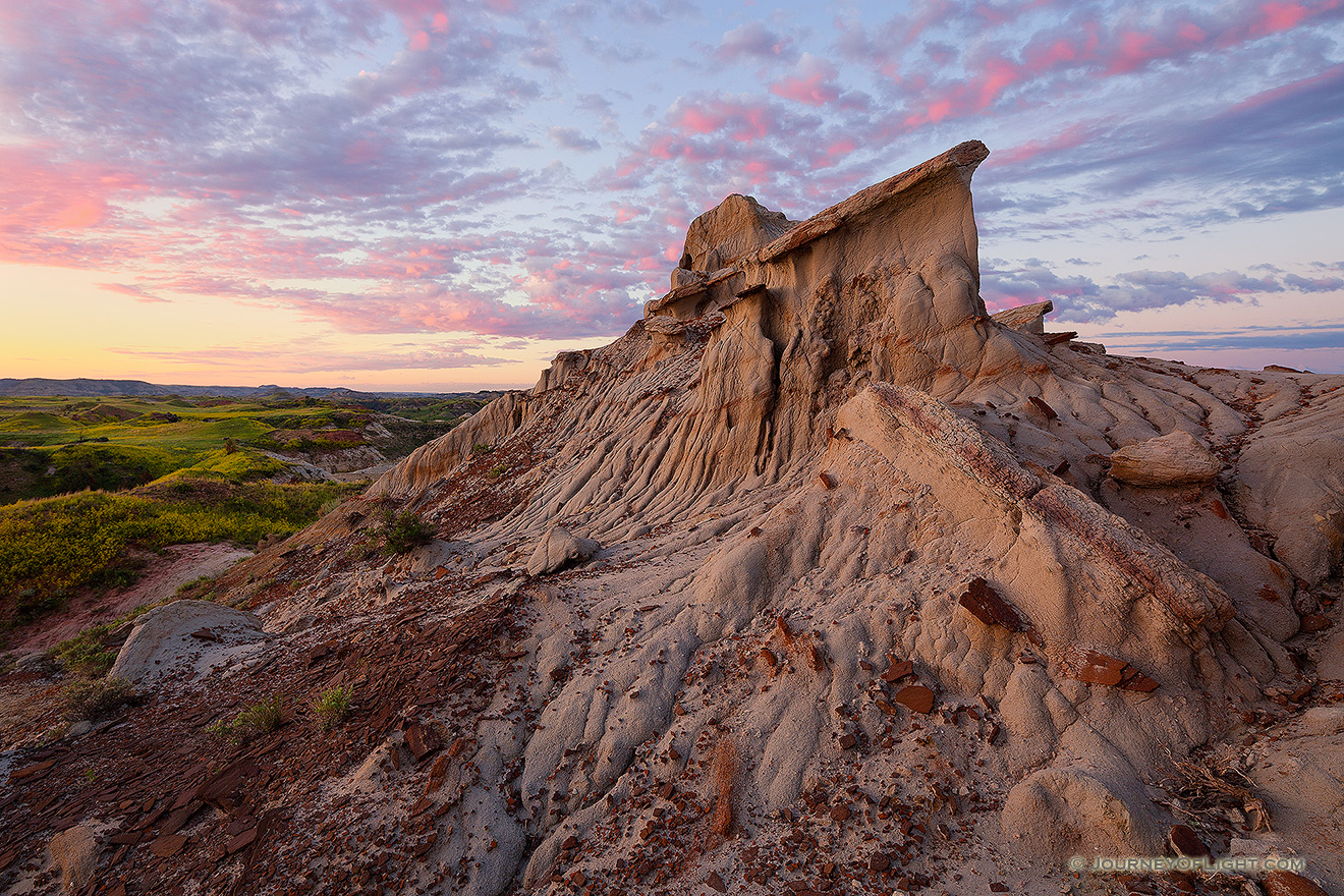 Clouds reflect the light of the rising sun across the High Plains in Theodore Roosevelt National Park. - North Dakota Picture