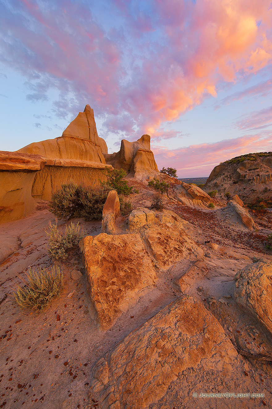 Clouds illuminated by the morning sun swirl above the badlands in western North Dakota in Theodore Roosevelt National Park. - North Dakota Picture