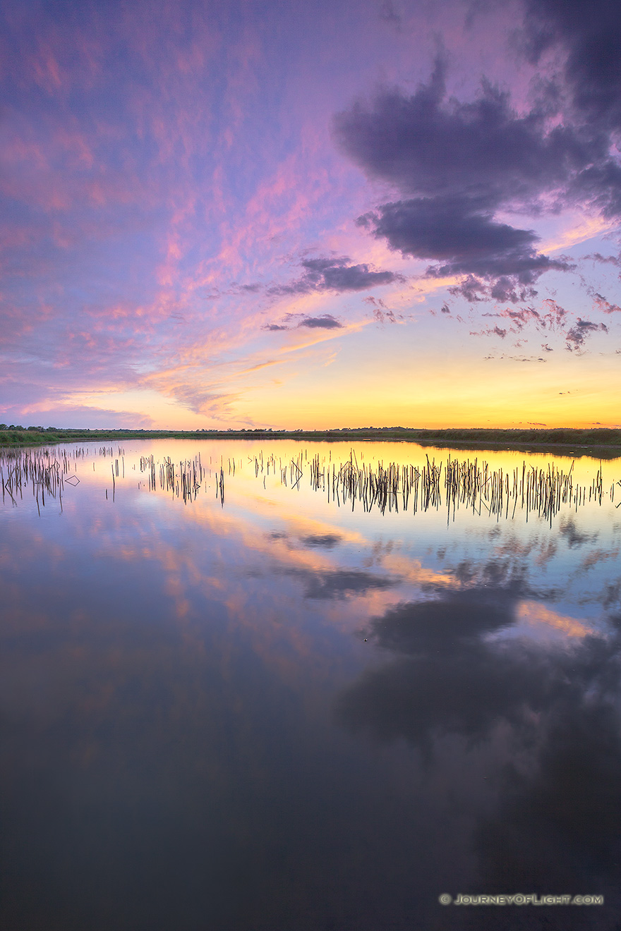 A scenic landscape photograph of a sunset reflected in the water at Jack Sinn WMA in eastern Nebraska. - Jack Sinn Picture
