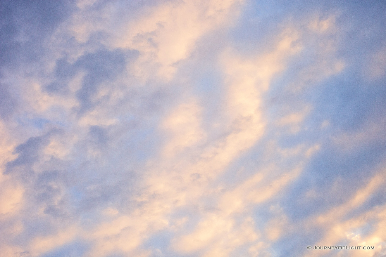 Light from the setting sun illuminates clouds in an abstract pattern on a chilly February evening. - Nebraska Picture