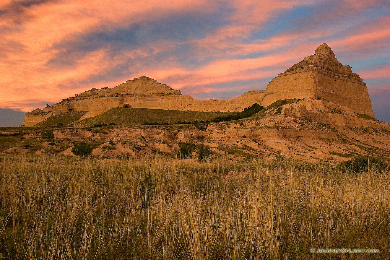 Scotts Bluff National Monument in western Nebraska.  Towering eight hundred feet above the North Platte River, Scotts Bluff has been a natural landmark for many peoples, and it served as the path marker for those on the Oregon, California, Mormon, and Pony Express Trails.  Scotts Bluff National Monument preserves 3,000 acres of unusual land formations which rise over the otherwise flat prairieland below. - Nebraska Picture