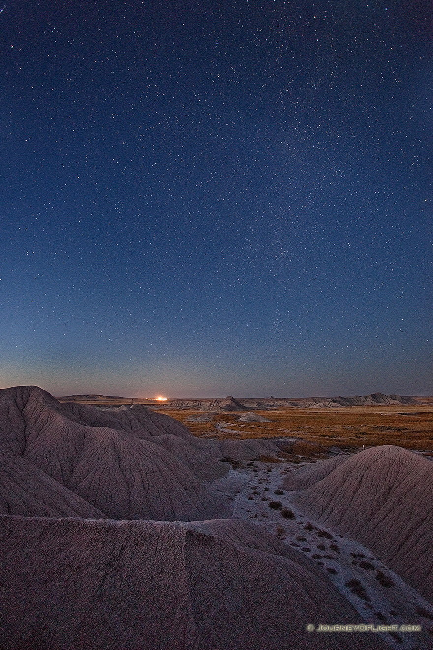 Stars fill the night sky while a train waits on the horizon at Toadstool Geologic Park near Chadron in western Nebraska. - Toadstool Picture