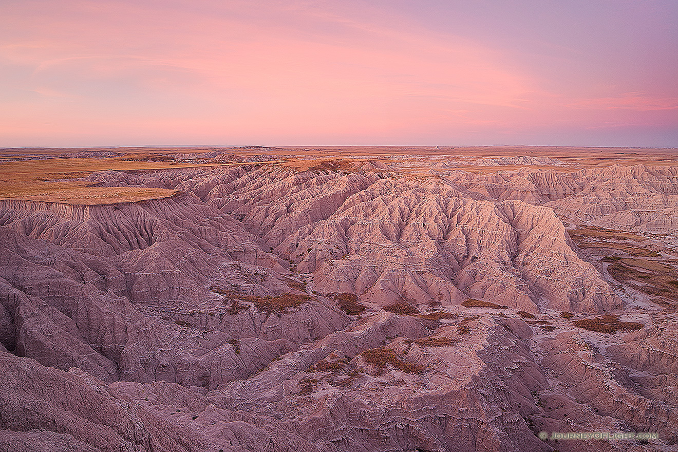 On a warm autumn evening from high on the plains, the last light of the day gives the canyons of the Oglala National Grassland just off the Hudson-Meng trail in western Nebraska a warm glow. - Nebraska Picture